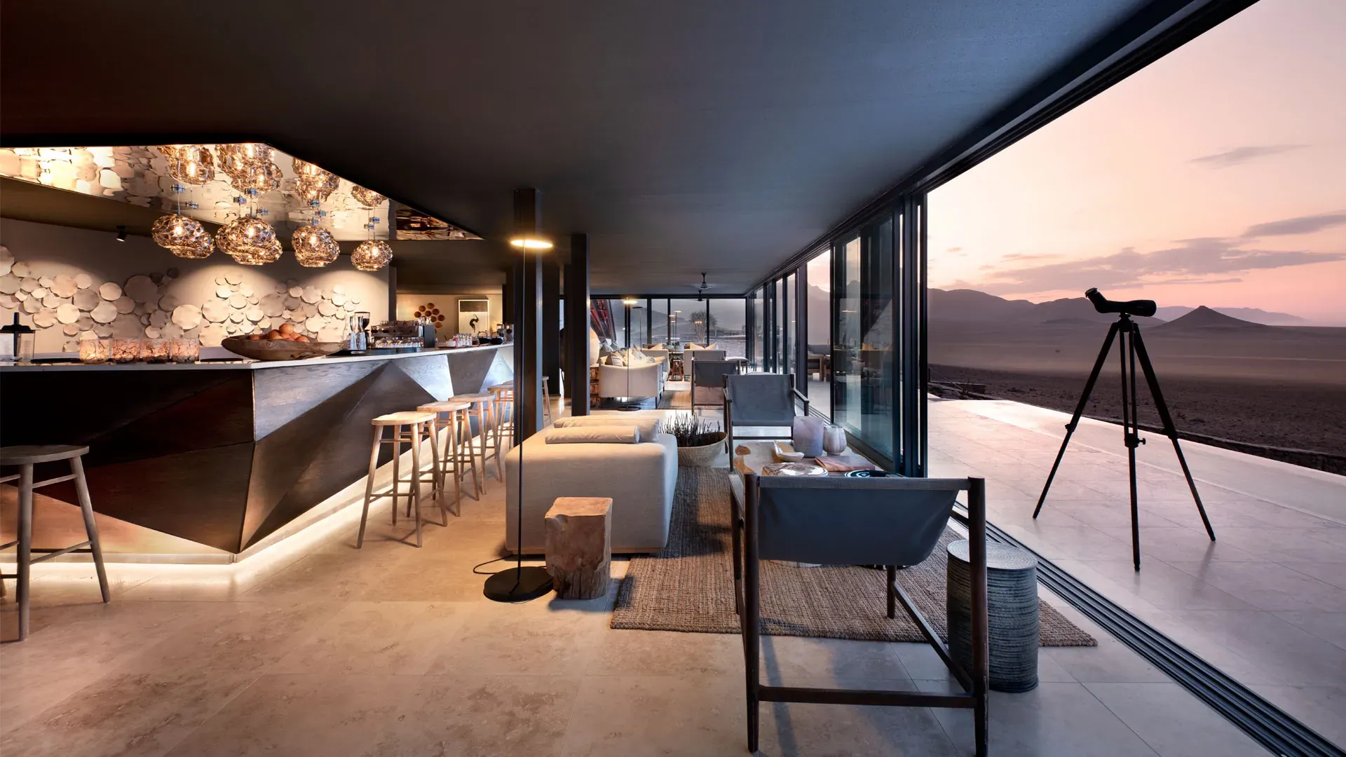 Interior of andBeyond Sossusvlei Desert Lodge featuring a modern luxury lounge with panoramic desert views