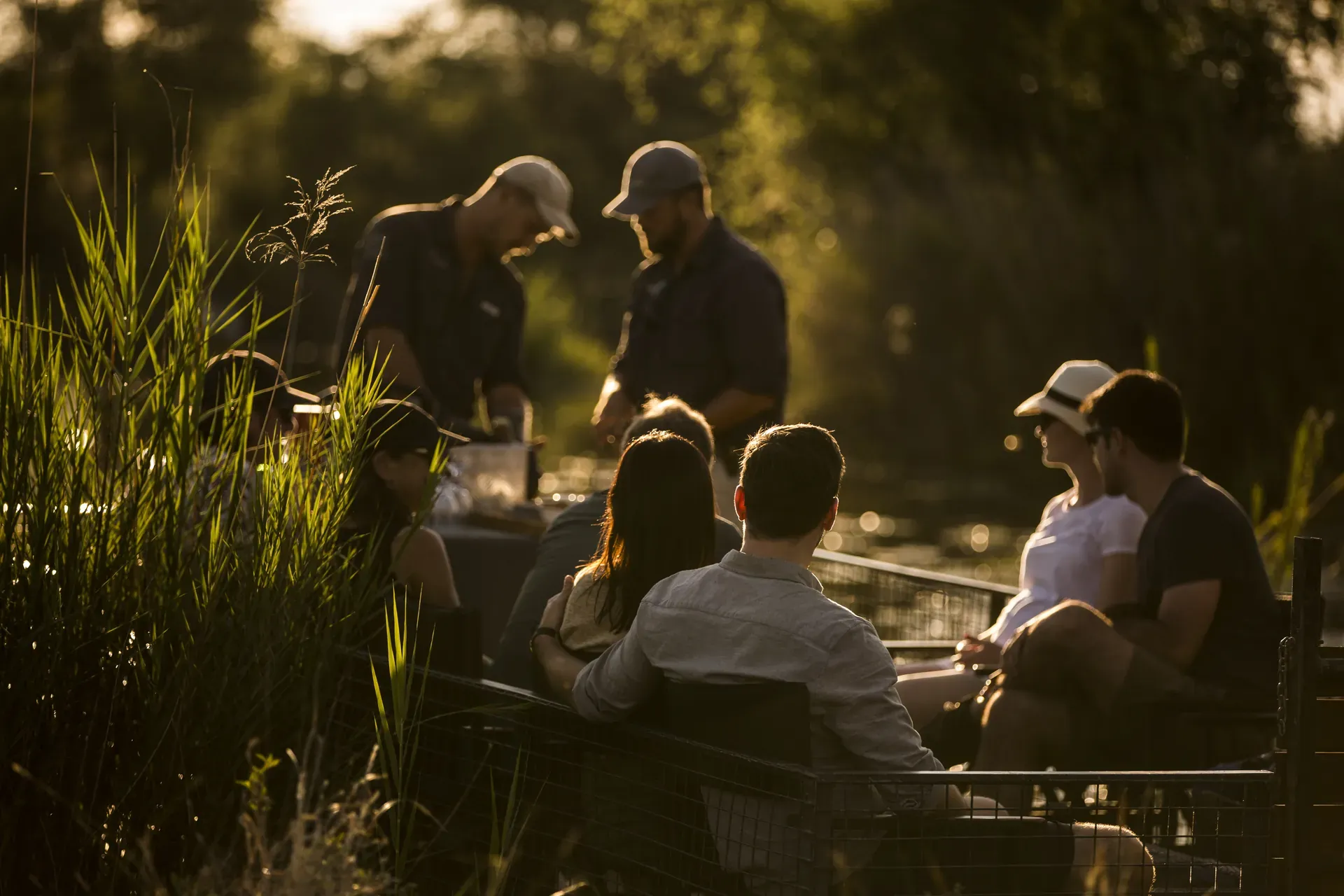 Group of people socializing outdoors in a lush garden setting, ideal for groups of six to twenty