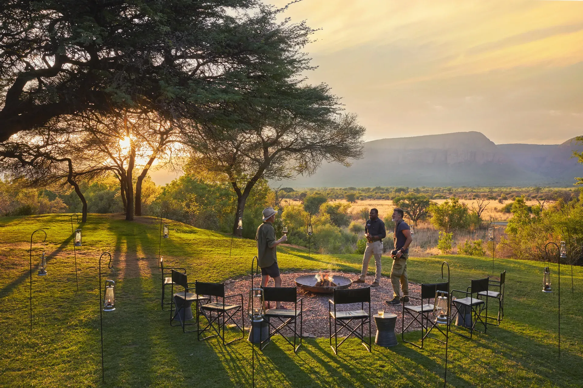 Marataba Safari fire deck at sundown featuring seating around a glowing fire pit overlooking the bush landscape