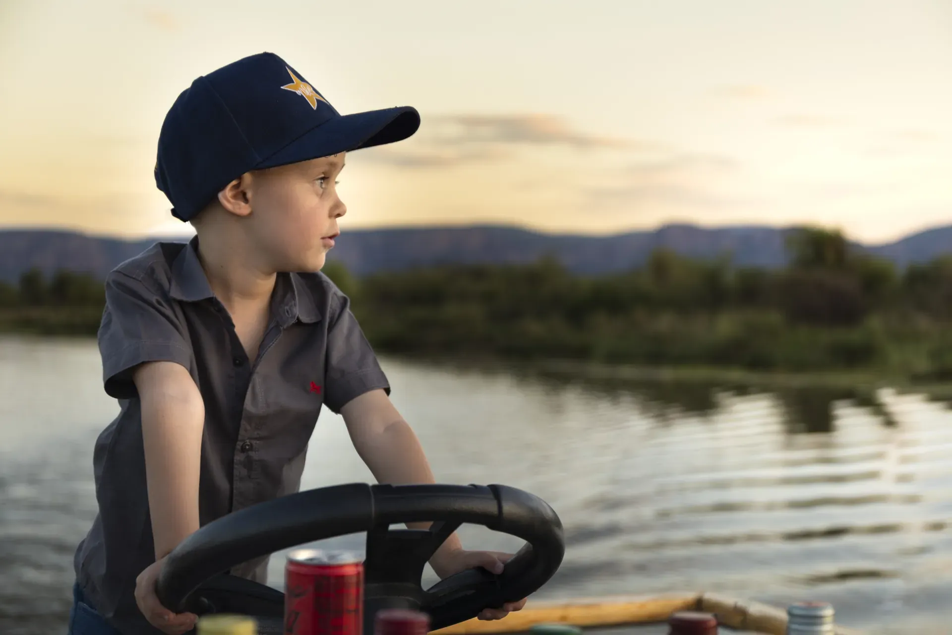 Marataba – Kid driving the boat on the Miss Mara sunset cruise.
