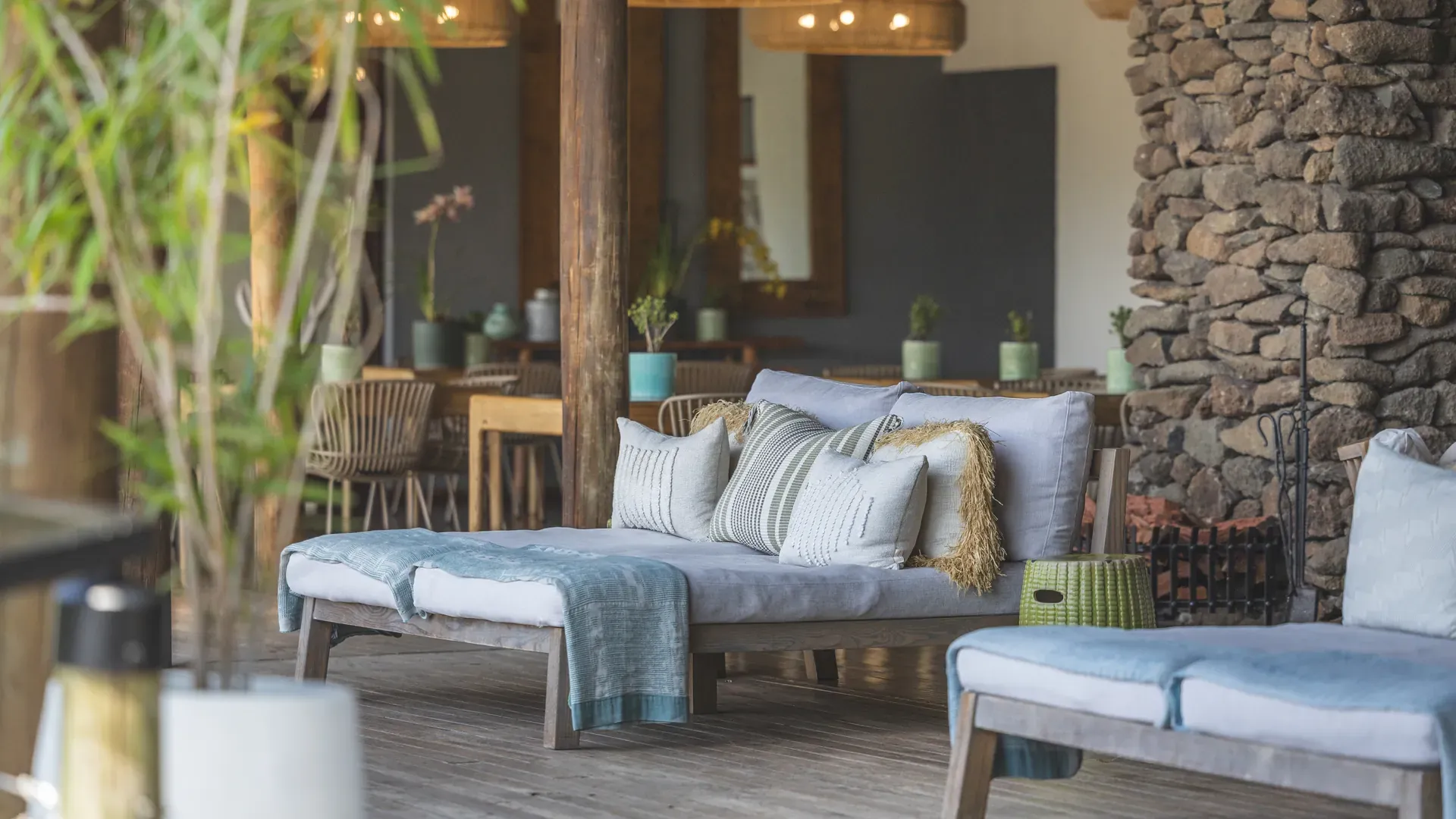 Elegant lodge lounge area decorated with a plush sofa, patterned cushions, and wooden coffee table