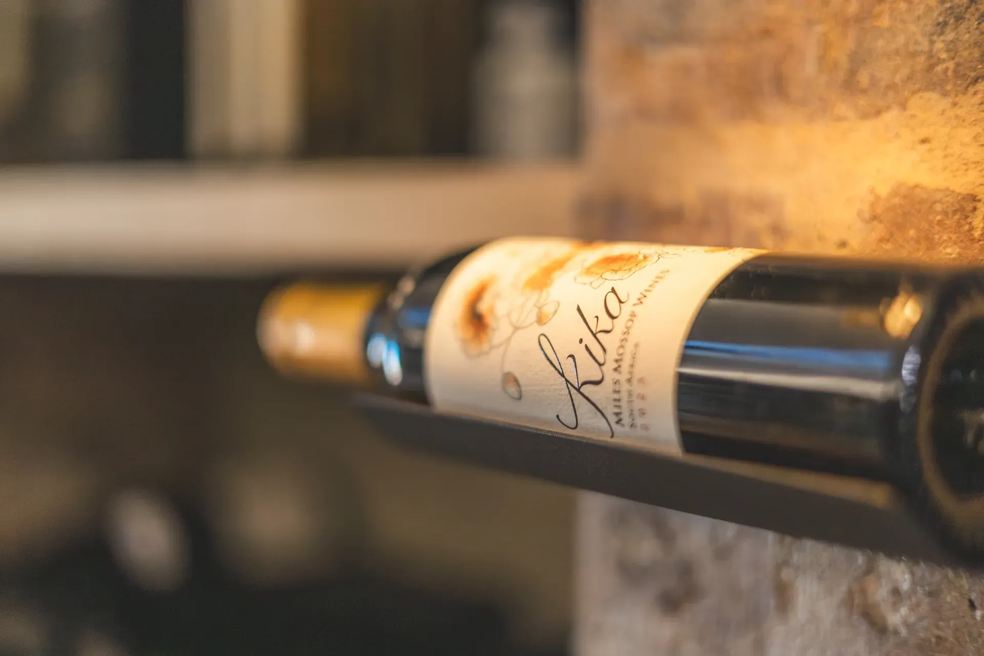 Bottle of Milles Mossop Kika wine displayed in the Monwana Lodge cellar.