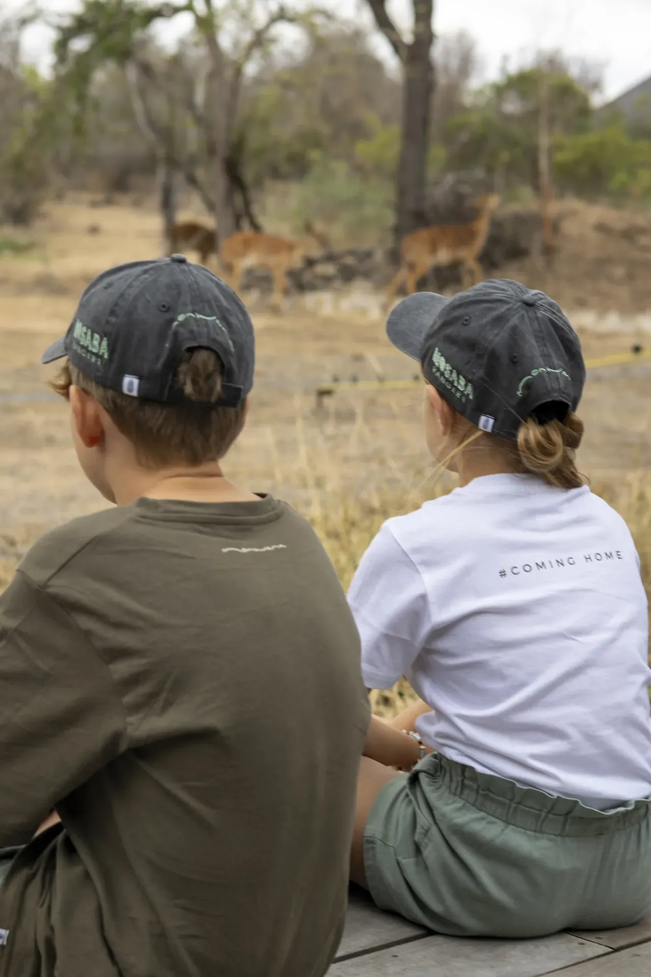 Children watching wildlife in the African bush.